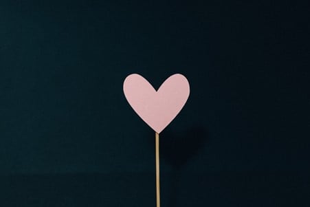 Heart shaped pink lollipop stencil on wooden stick