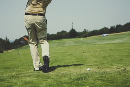 Man playing golf on a golf course 