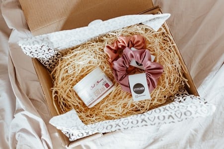 Spa box filled with hay, face cream and scrunchies