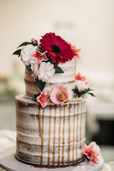 Bespoke Mother's Day cake with dripped icing and roses on top 