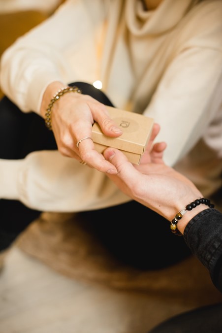 Daughter handing gift box over to mother on Mother's Day