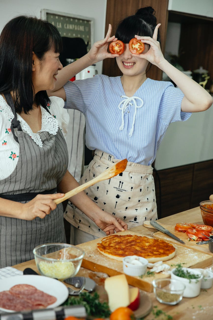 Mother and daughter cooking in kitchen